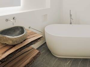 Holz und Stein – so wie sie auch in der Natur vorkommen – werden hier gemeinsam in Szene gesetzt und stehen in gelungenem Kontrast zur weissen Wanne. Itel AG.