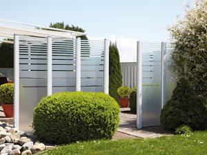 Glaswände schützen den Gartensitzplatz vor Zugluft und fremden Blicken, ohne Licht wegzunehmen. Tomwood.