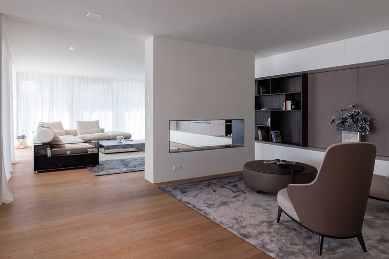 Die Feuerstelle wirkt als Raumteiler im Wohnbereich.