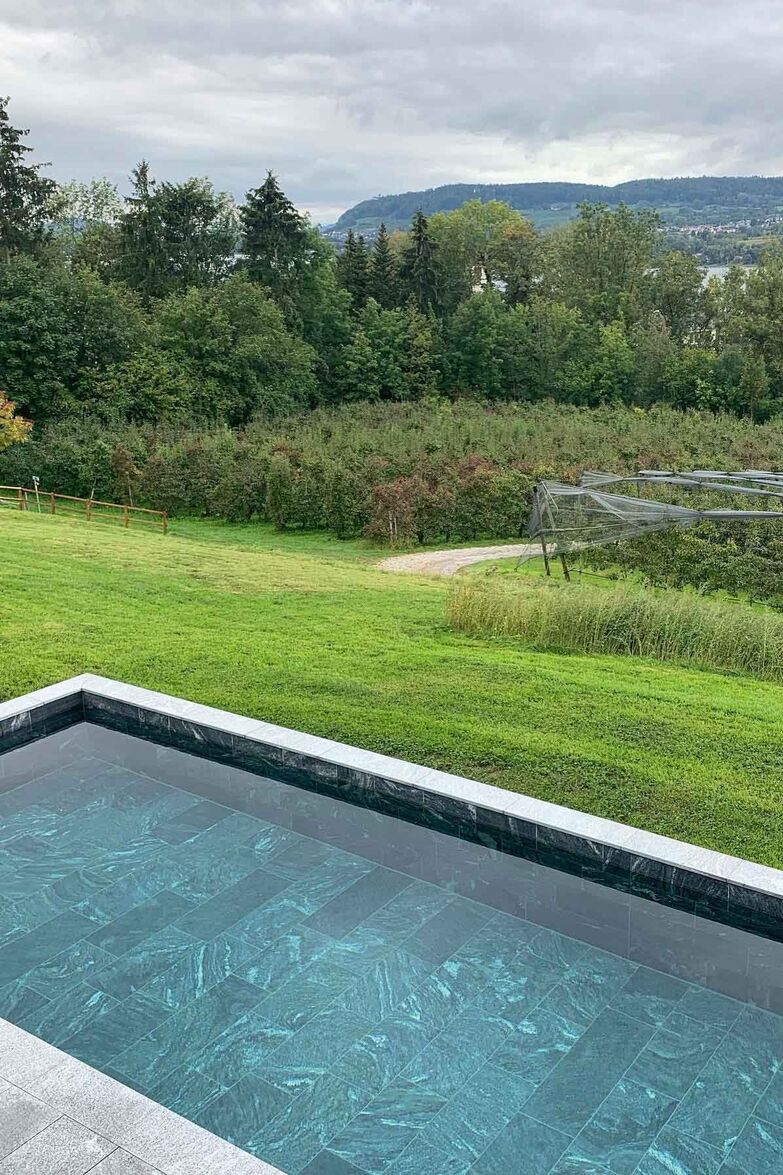 SwissBioPool/Tom Schmid Wassergarten: Bei diesem Neubauprojekt wurde der Biopool zusammen mit den kompletten Umgebungsarbeiten ausgeführt. Im neuen Becken aus heimischen Gneisplatten verändert sich der Farbton des Wassers je nach Sonneneinstrahlung und Witterung wie in einem natürlichen See. Technik: SwissBioPool. www.swissbiopool.ch Umsetzung: Tom Schmid Wassergarten.www.schmid-wassergarten.ch