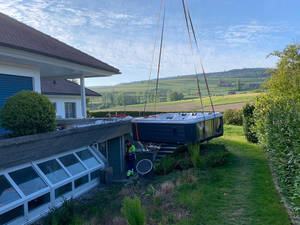 Der Whirlpool hängt am Kran und wird zunächst vor dem Haus abgesetzt.